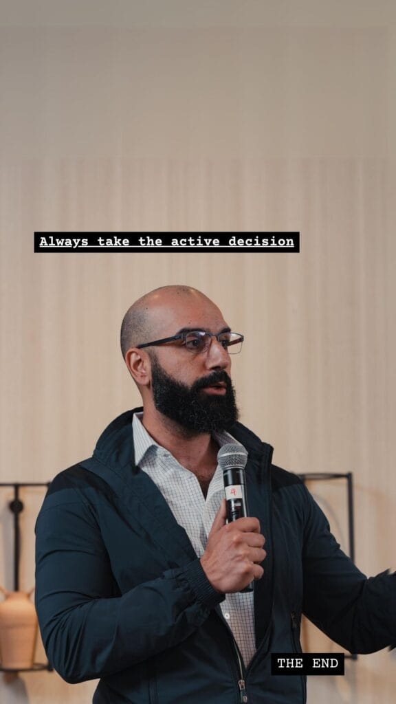 Ayman Al-Abdullah speaking into a microphone, captioned Always take the active decision